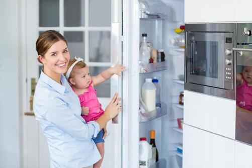 mom daughter opening fridge